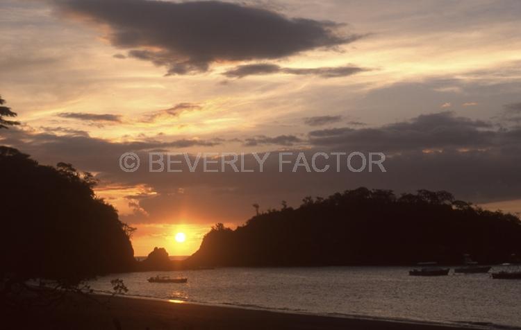 Sunset;colorful;sky;el ocdtal costa rio;cloudsl sun;yellow;water;boat;sillouettes;anchorages;ocean